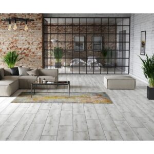 Loft cu perete de cărămidă, canapea gri și covor galben, pe parchet laminat gri albit Classen Arteo 54846